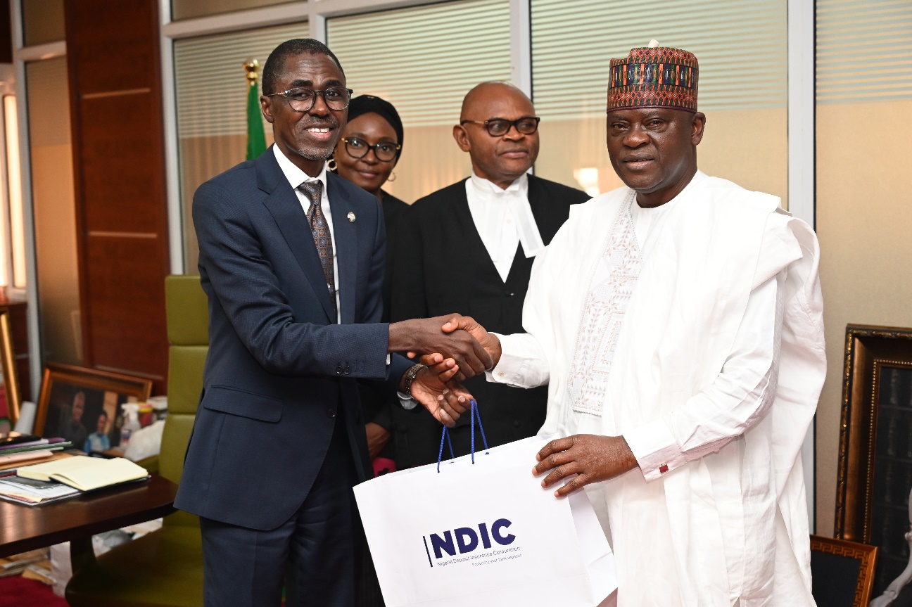 MD/CE, Nigeria Deposit Insurance Corporation (NDIC), Bello Hassan presents the NDIC research publications to the Chief Judge of the FCT High Court, Honourable Justice Husseini Baba-Yusuf along with Honourable Justice S. C. Orji and Honourable Justice M. F. Anenih during the NDIC Management’s visit to the FCT High Court, Abuja.