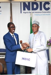 MD/CE, Nigeria Deposit Insurance Corporation (NDIC), Bello Hassan, presenting NDIC’s research publications to the visiting President and Chairman of Council, Chartered Institute of Directors (CIoD), Alhaji Tijjani M. Borodo, FIoD, during the Governing Council’s courtesy visit to the NDIC’s Management in Abuja.