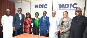 MD/CE, Nigeria Deposit Insurance Corporation (NDIC), Mr Bello Hassan (middle) and the NDIC Executive Director Corporate Services, Mrs Emily Osuji (2nd Right) pose  for   a   group   photograph   with   members  of   the   Governing   Council   of the Chartered Institute of   Directors (CIoD)  led  by the  President  and Chairman  of Council, Alhaji Tijjani M. Borodo (3rd Right) during the courtesy visit of the CIoD Governing Council to the NDIC’s Management at the Corporation’s Head Office in Abuja.