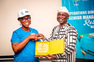 Director General, NIMASA, Dr. Dayo Mobereola presenting a plaque to the Coordinator, Western Zone, NIMASA, Gloria Anyasodo during a retreat organized by the Operations Directorate of NIMASA in Lagos