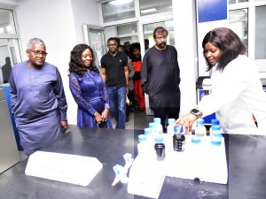 President/CE, Dangote Industries Ltd (DIL), Aliko Dangote; Coordinator, Technical Committee of the One-Stop Shop (OSS) for Sale of Crude and Refined Products in Naira Initiative, Maureen Ogbonna; Vice President, Oil and Gas, DIL, Devakumar Edwin, look on as Assistant Quality Assurance Officer, Dangote Petroleum Refinery Laboratory, Nwankwor Favour Alex, shows samples of products from the refinery during the visit of the Technical Committee to Dangote Petroleum Refinery and Fertiliser Plant, Lekki, on Tuesday 17 June 2025.