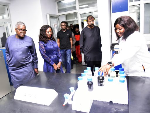 President/CE, Dangote Industries Ltd (DIL), Aliko Dangote; Coordinator, Technical Committee of the One-Stop Shop (OSS) for Sale of Crude and Refined Products in Naira Initiative, Maureen Ogbonna; Vice President, Oil and Gas, DIL, Devakumar Edwin, look on as Assistant Quality Assurance Officer, Dangote Petroleum Refinery Laboratory, Nwankwor Favour Alex, shows samples of products from the refinery during the visit of the Technical Committee to Dangote Petroleum Refinery and Fertiliser Plant, Lekki, on Tuesday 17 June 2025.