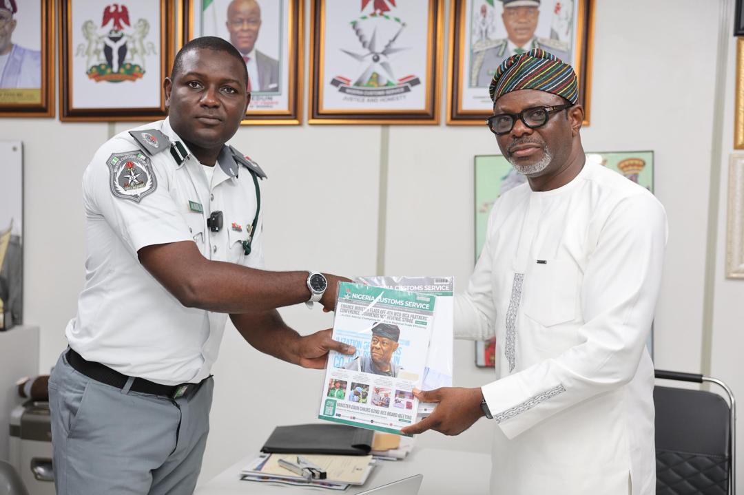 L-R: National Public Relations Officer of the Service, Assistant Comptroller of Customs Abdullahi Maiwada presenting a souvenir to renowned artificial intelligence strategist and digital consultant Celestine Achi, author of "AI-Powered PR: The Essential Guide for Communications Leaders to Master Artificial Intelligence,"