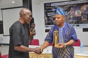 L-R: FiBOP President,  Mr Charles Onwuatogwu and NAIC Lagos Branch Manager,  Mr Titiloye Oyatolu receiving  FiBOP 's award of excellence  as 'Nigerian Farmers' Reliable partner 2025