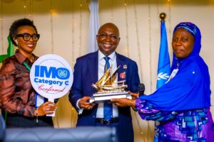 Director General, Nigerian Maritime Administration and Safety Agency, NIMASA, Dr Dayo Mobereola (middle) receiving a souvenir from the Director of Administration and Human Resources, NIMASA, Moji Jimoh (right) while the Head, Protocol Unit of NIMASA, Nancy Oluoha looks on during a surprise reception organized by staff of the Agency to commemorate Nigeria’s recent election into the Category C Council of the IMO at the NIMASA headquarters in Lagos.