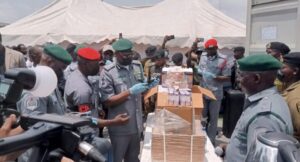 Adewale Bashir Adeniyi with some seized goods and drugs on display 