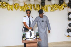 L-R: Nafisat Balogun and the Managing Director of the Customs Technical Hangar Service, retired Comptroller of Customs, Captain Kuhi Mbaya cutting the cake in celebration of Nafisat's remarkable achievement of obtaining a commercial multi-engine pilot license in the United States of America 