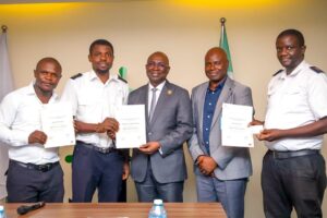 Director General, Nigerian Maritime Administration and Safety Agency, NIMASA, Dr. Dayo Mobereola (Middle), Head, Nigerian Seafarers Development Programme (NSDP) Unit of NIMASA, Captain Omotosho Adebayo (second right) in a group photograph with NSDP graduates displaying their certificates when they paid an appreciation visit to the DG at the headquarters of the Agency in Lagos.