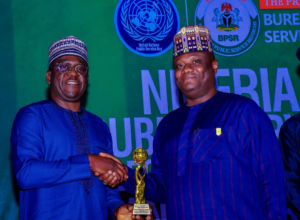 L-R: Engr. Abraham Oshadami, Executive Commissioner, Technical Services, Nigerian Communications Commission (NCC); Dr. Abubakar Ibrahim Kana, Permanent Secretary, General Services Office, Office of the Secretary General to the Government of the Federation during the Nigerian Public Service Award and Gala Night where NCC recieved the award for 3rd Best Performing MDA at Nicon Luxury Hotel, Abuja on the 23rd June, 2026.