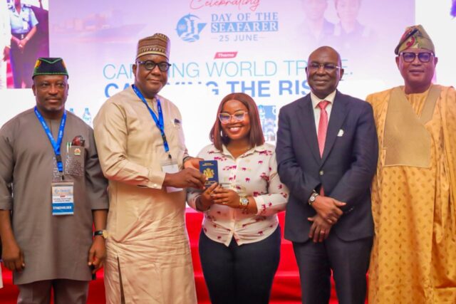L-R: Deputy Chairman, House of Representatives Committee on Maritime Safety, Education and Administration, Hon. Uduak Odudoh; Director, Maritime safety and security, Federal Ministry of Marine and Blue Economy, Mr. Makoji Musa; representing the Honourable Minister; a Female Seafarer displaying the Seafarers Discharge Book; Director General, Nigerian Maritime Administration and Safety Agency, NIMASA, Dr Dayo Mobereola; Chairman, Senate Committee on Marine Transport; Senator Wasiu Eshinlokun Sanni; during the celebration of 2026 Day of the Seafarers in Lagos, Nigeria.