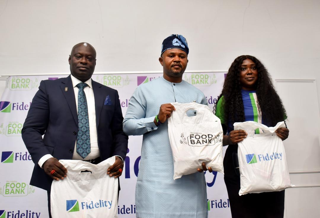 L-R: Branch Leader, Fidelity Bank Plc, Uromi, Joseph Ero; Commissioner for Agriculture and Food Security, Edo State, Jerry Uwangue; and Team Lead, CSR, Fidelity Bank Plc, Victoria Abuka; at the Fidelity Food Bank distribution event held at Udomi, Irrua, in Esan Central Local Government Area, Edo State