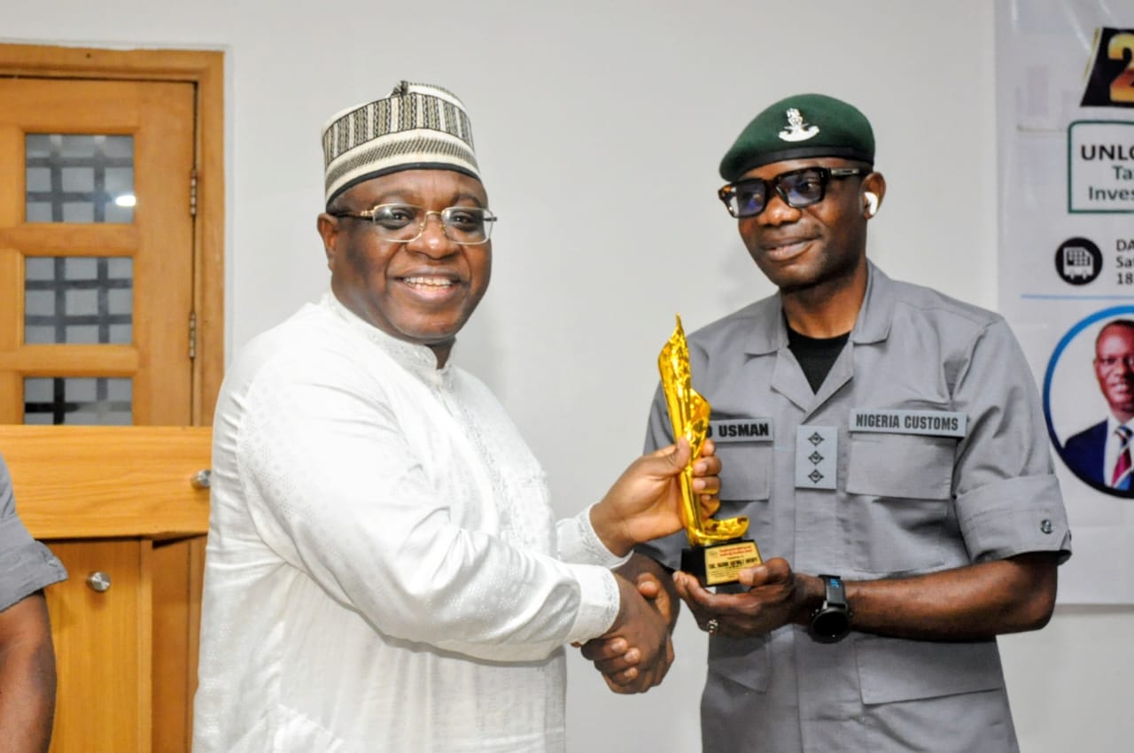 L-R: Chairman NGX Group, Alhaji (Dr ) Umaru Kwairanga presenting the Transformative and Leadership Excellence Award to Comptroller General of Nigeria Customs Service, Adewale Bashir Adeniyi, who was represented by DSC, A O. Usman at the FiBOP 2026 annual conference and awards held on Saturday 17th October, 2026